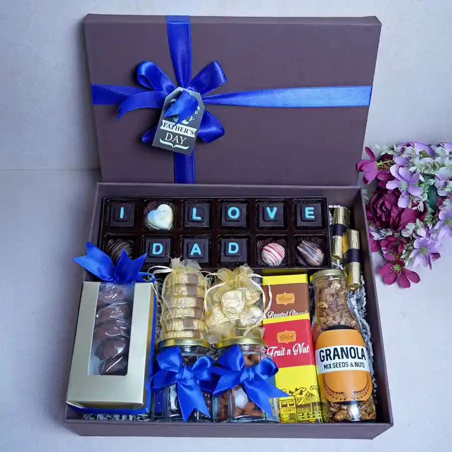 Assorted chocolates and gourmet treats hamper featuring Oreo, Cranberry, Orange chocolates, truffles, white chocolates, almond Florentines, cookies, chocolate bars, and chocolate-coated raisins and almonds