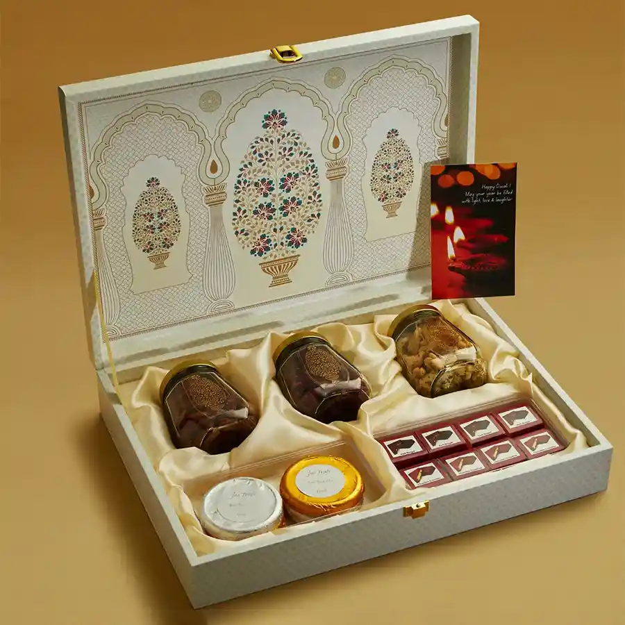 Diwali Joyful Gourmet Box featuring a wooden box with Indian designs, filled with Peri Peri Almonds, Pepper Cashews, Masala Cranberries, chocolate-coated nougat crunchies, and chocolate biscuits, with a free personalized card.