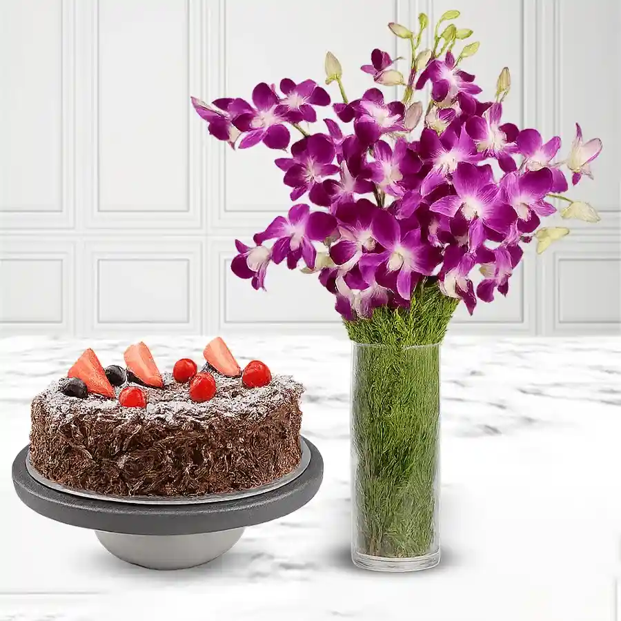 A luxurious gift set featuring a rich Black Forest cake and 12 vibrant orchids elegantly displayed in a glass vase.