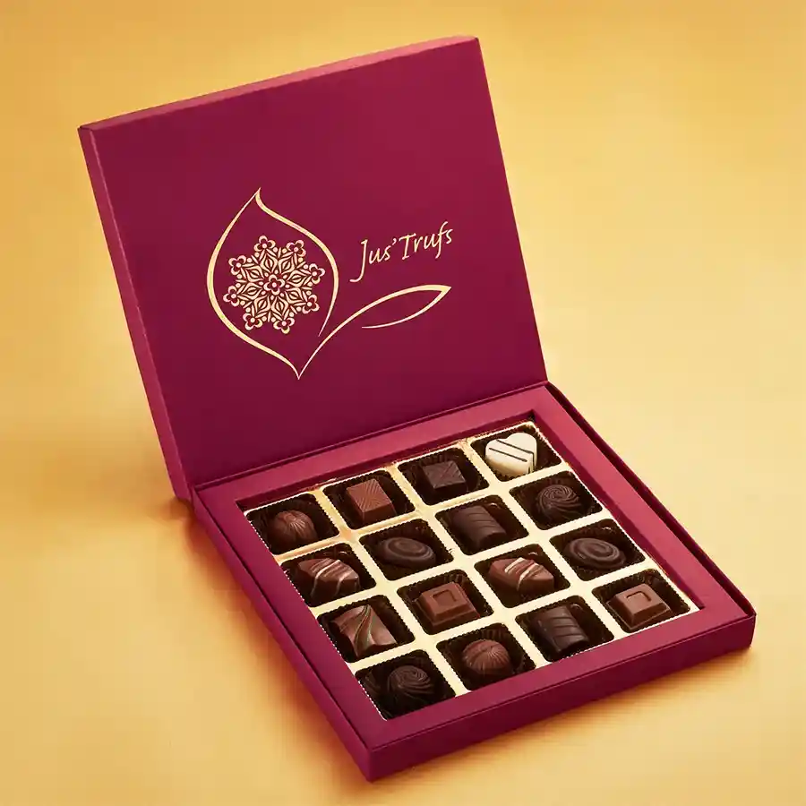 A vibrant box featuring a colorful Mandala design containing 16 assorted handcrafted chocolate truffles in flavors like Almond, Bittersweet Dark, Orange Duet, and Strawberry Melody.