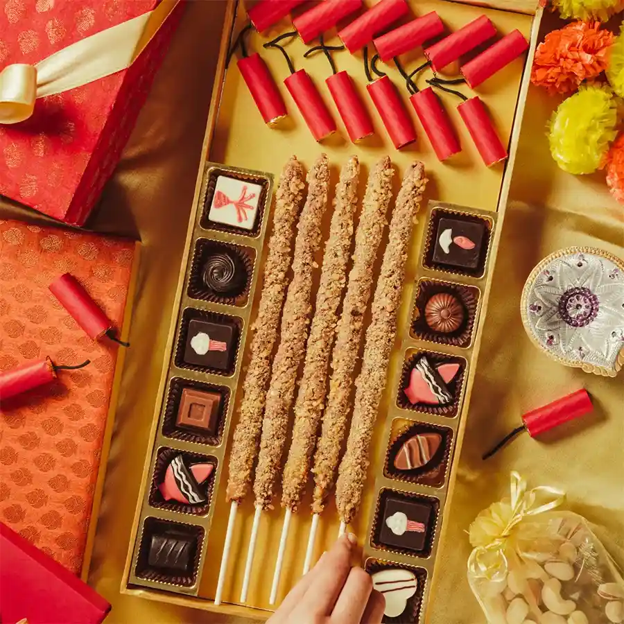 Sweet Celebrations Chocolate Collection in an elegant wooden box featuring edible Diwali crackers, chocolate butterscotch phooljadis, and assorted truffles.