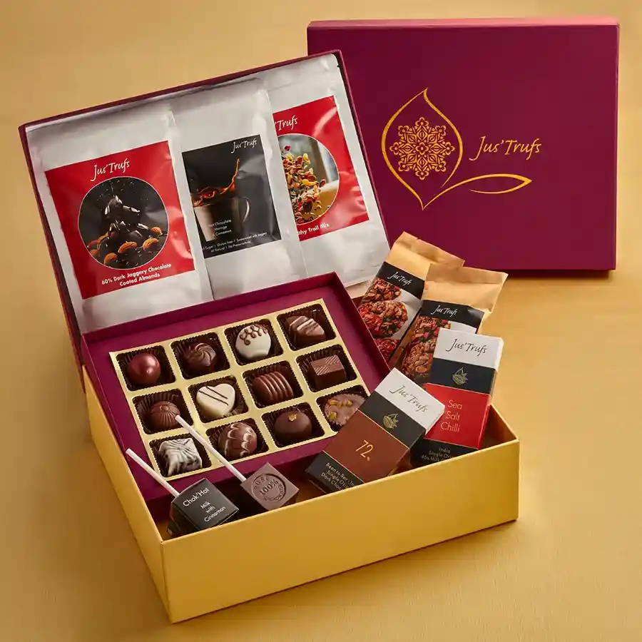 Wholesome Chocolaty Goodies Combo featuring chocolate truffles, vegan nut bars, chocolate bars, hot chocolate sticks, trail mix, and dark chocolate-covered almonds in a mandala gift box