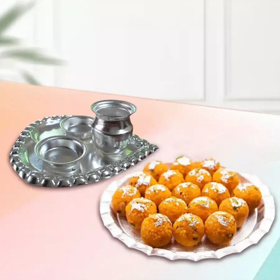 Haldirams Motichur Laddu in a decorative box alongside a silver-plated Paan-shaped Aarti Thali