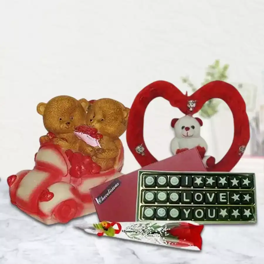 Exceptional I Love You Gift Hamper featuring Couple Teddy with Umbrella, homemade alphabet chocolates, cuddly Teddy in a heart-shaped soft toy, and artificial red rose.