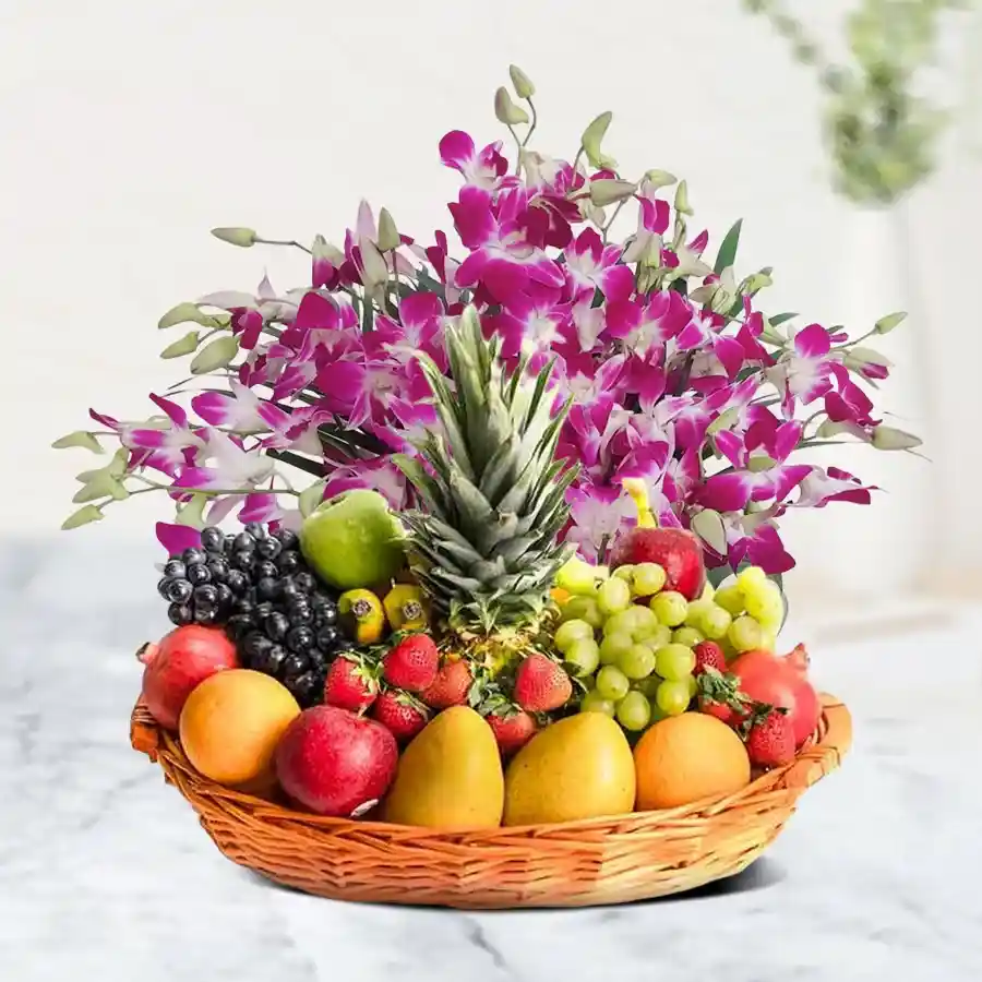 A beautifully arranged fruits basket featuring apples and seasonal fruits, accented with elegant orchid stems.