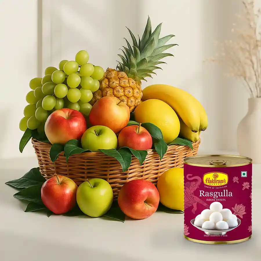 A basket filled with assorted fresh fruits and a tin of Haldiram Rasgulla, perfect for gifting to Mummy.