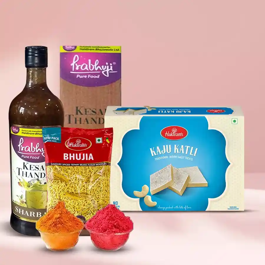 Assorted Holi treats including Haldirams Kesar Thandai, Kaju Katli, Bhujia, and Herbal Gulal in a festive presentation