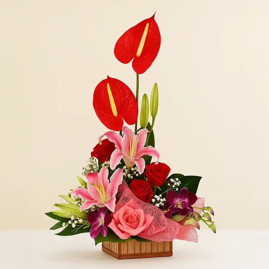 Affectionate Flowery Gift Basket featuring 19 assorted blooms including Red Roses, Anthurium, and Purple Orchids, beautifully arranged in a decorative basket.