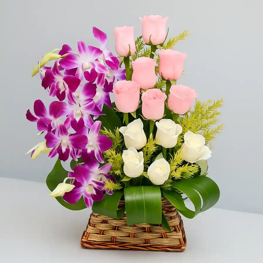 Enchanting Floral Symphony in Basket with assorted roses and orchids.