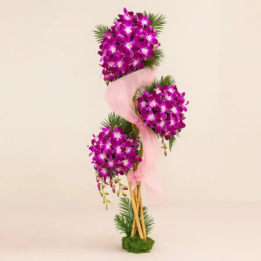 Majestic purple orchid arrangement featuring 100 blooms in chiffon wrap, 3 feet tall, ideal for weddings, anniversaries, and birthdays.