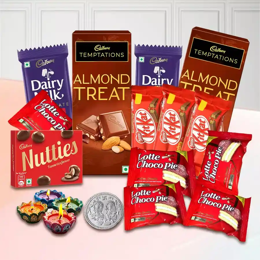Excellent Collection of Chocolate Gifts for Diwali featuring Cadbury Nutties, Temptation Chocolates, Nestle KitKats, Dairy Milk Fruit & Nut Bars, Lotte Chocopie, a shimmering Laxmi Ganesh silver coin, and diyas arranged beautifully.