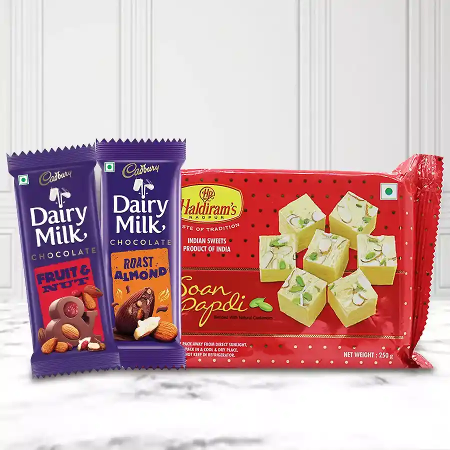 Enticing Choco N Sweets Gift Hamper featuring Haldiram’s Soan Papdi, Cadbury Dairy Milk Fruit & Nut, and Cadbury Dairy Milk Roast Almond bars