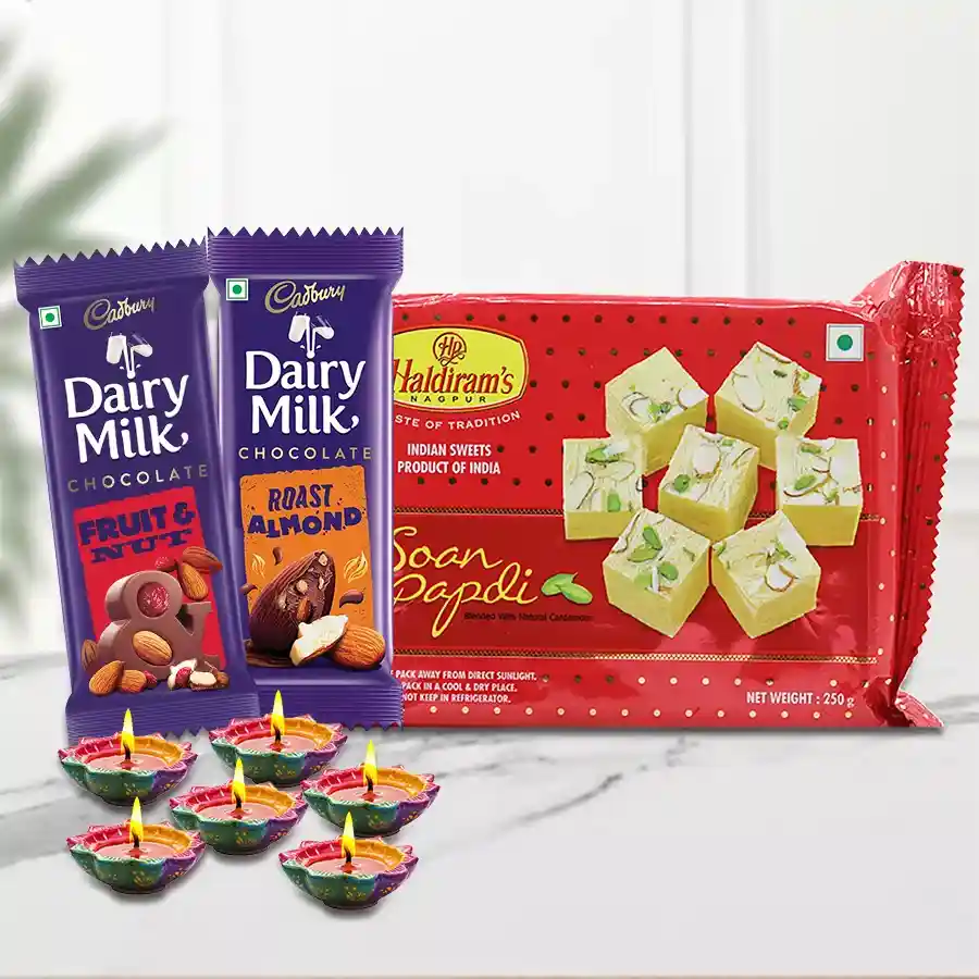 Diwali Time Celebration Gift Hamper featuring Haldirams Soan Papdi, wax diyas, and Cadbury Dairy Milk bars