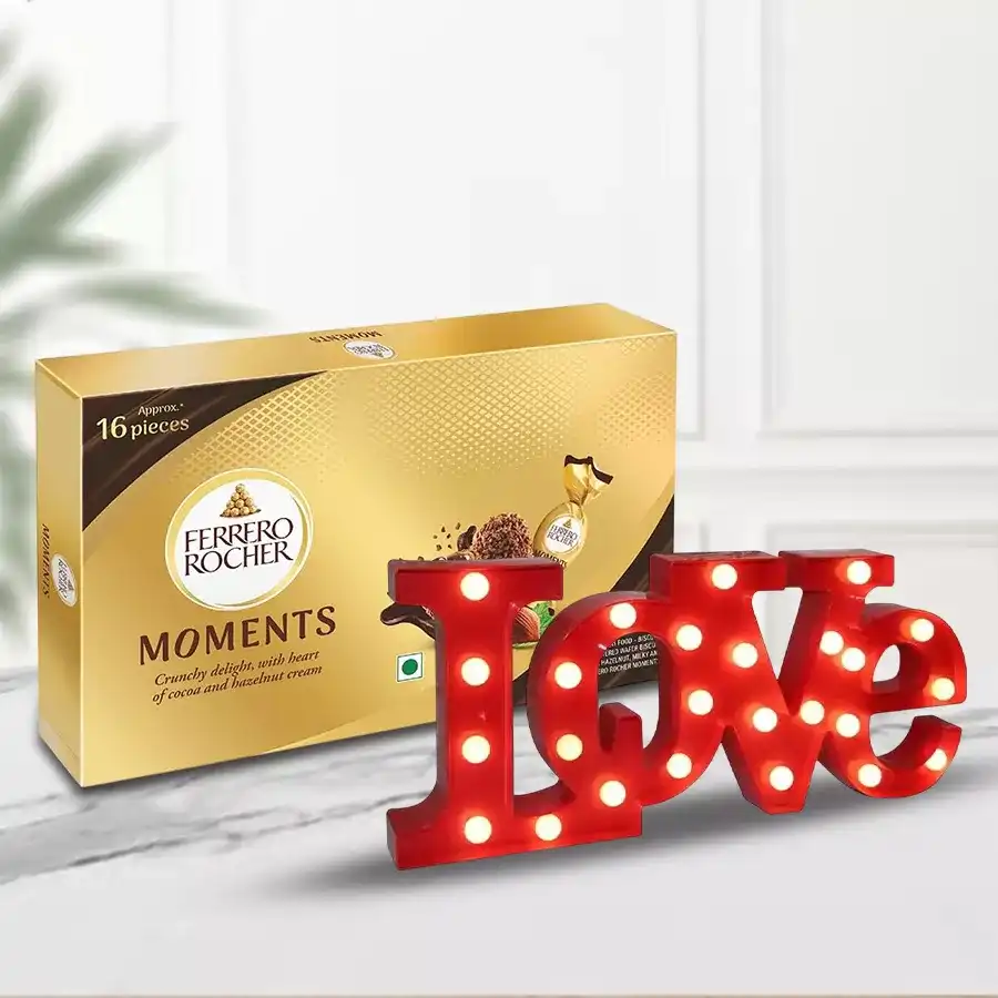 LOVE LED Lamp with Ferrero Rocher chocolates on a decorative background