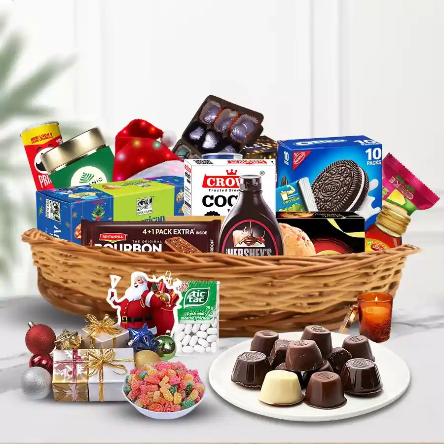 Mouth Watering Christmas Gift Basket filled with festive treats, including fruit cakes, cheeses, chocolates, biscuits, Red Bull, organic tea, LED lights, and a Santa cap.