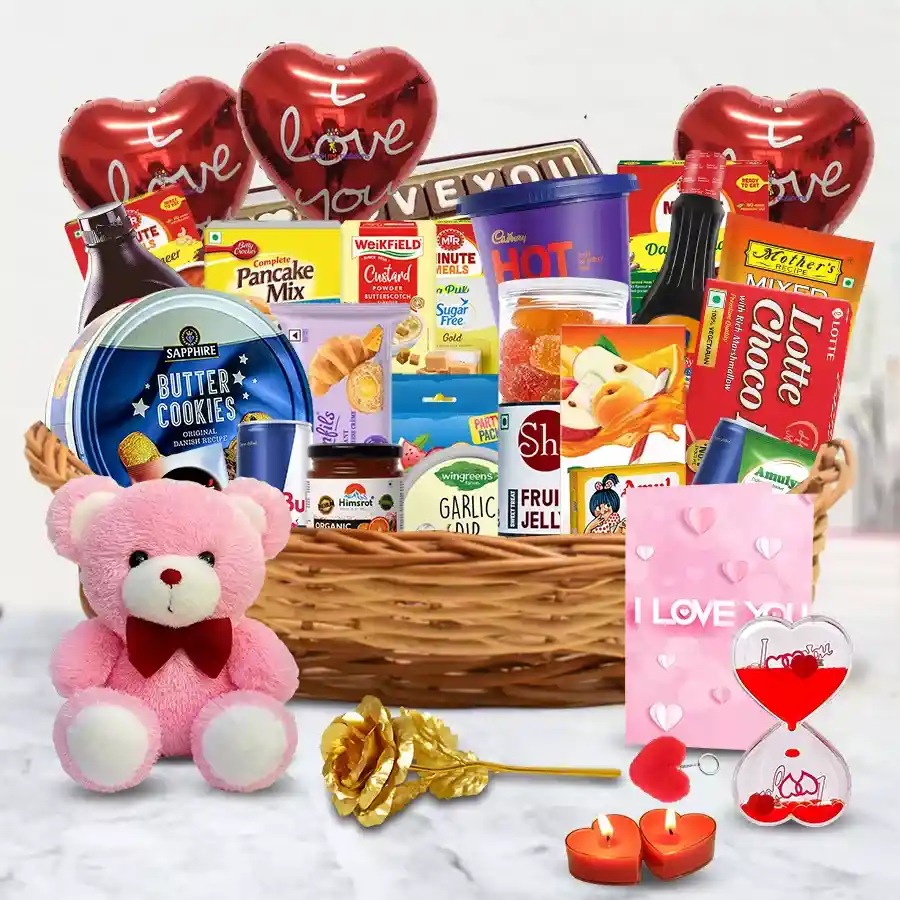 A beautifully arranged Valentine brunch basket filled with Sapphire Cookies, Amul Butter, Hershey's Chocolate Syrup, handmade chocolates, a teddy bear, heart-shaped candles, a golden rose, and a heartfelt card, all set for a romantic celebration.