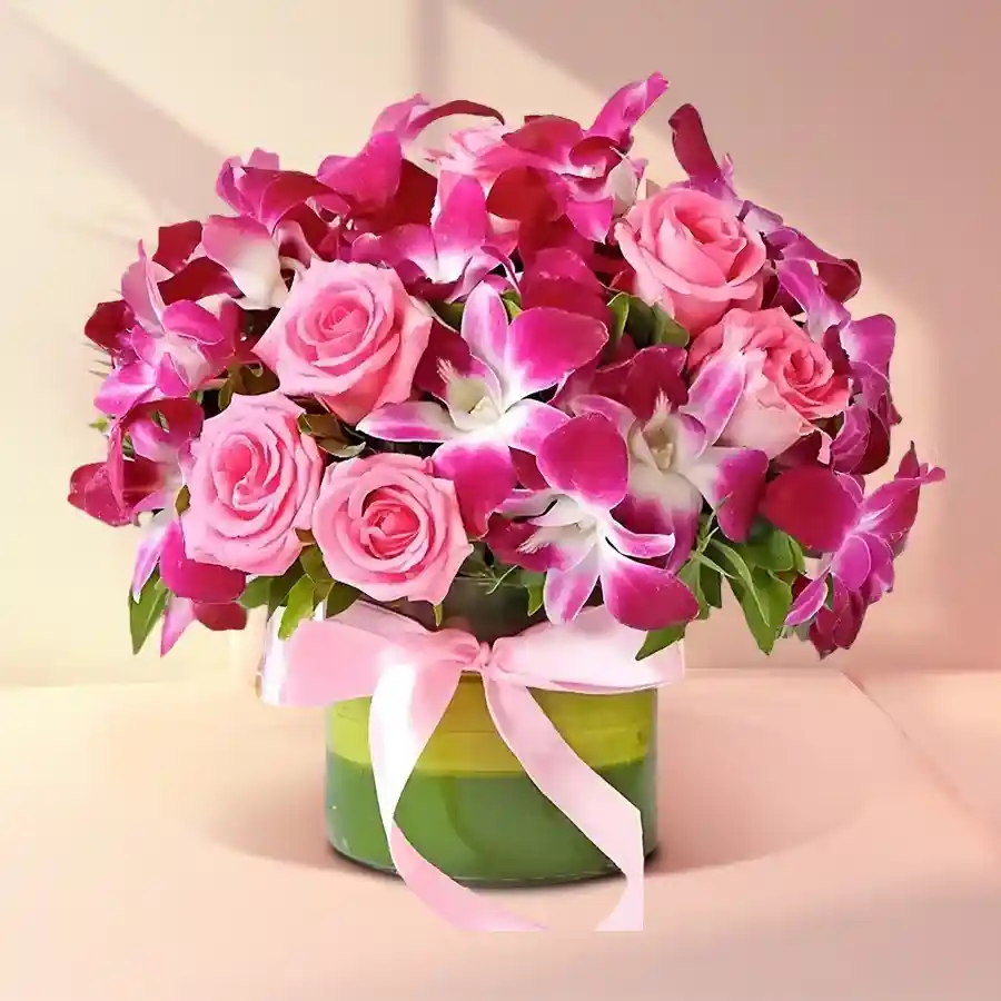 Elegant arrangement of pink roses and purple orchids, perfect for gifting and expressing love.