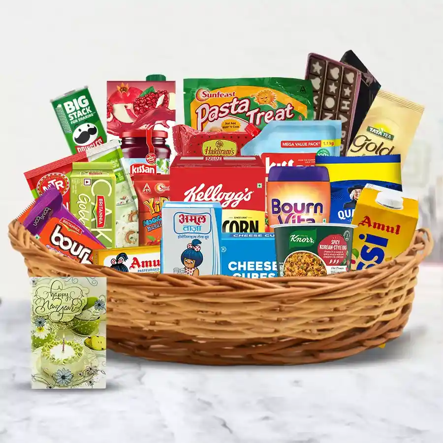 Epitome of Taste and Delicacy Gift Basket filled with premium treats including Amul Butter, Britannia Cheese, Amul Lassi, Cadbury Bournvita, Kellogg’s Corn Flakes, Quaker Oats, Sunfeast Noodles, Haldirams Soan Papdi, a Happy New Year chocolate, and a greeting card.