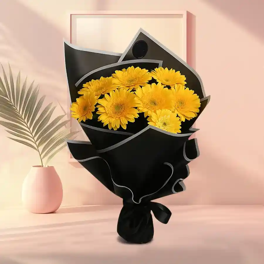 Bouquet of five yellow gerberas wrapped in tissue paper, exuding joy and warmth.