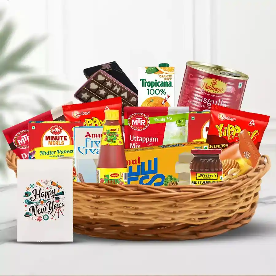 Succulent Collection of Ingestas basket filled with Amul Cream, Britannia Cookies, MTR meals, Haldirams snacks, Tropicana juice, chocolates, and a greeting card for New Year celebration.