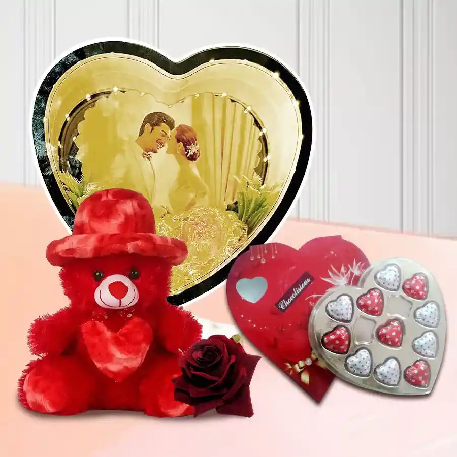 Glamorous personalized photo magic mirror gift set with heart-shaped chocolates, a red teddy bear, and a red velvet rose for Valentine's Day.