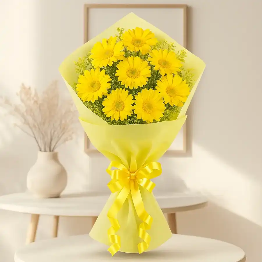 A vibrant bouquet of 15 yellow gerberas wrapped in tissue, perfect for bringing warmth and joy to any occasion.