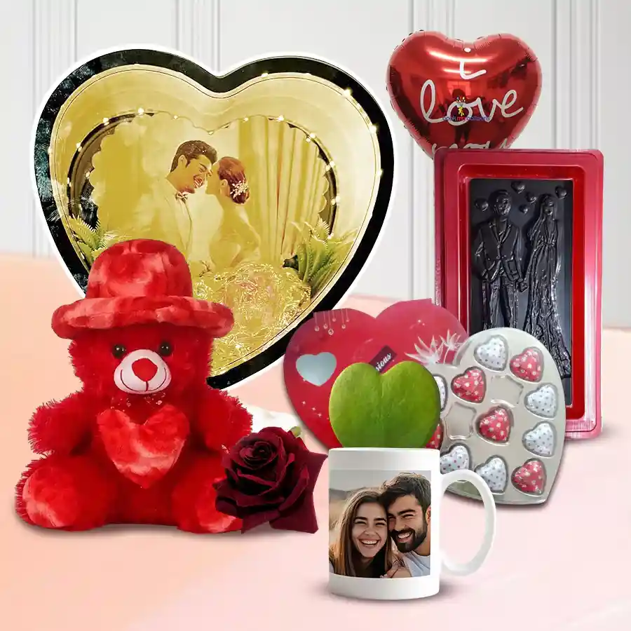 Admirable Jumbo Valentine Gift Combo featuring a personalized photo heart magic mirror, red teddy bear, heart-shaped chocolates, custom photo coffee mug with a sweet plant, red velvet rose, "I Love You" mylar balloon, and special Valentine chocolates