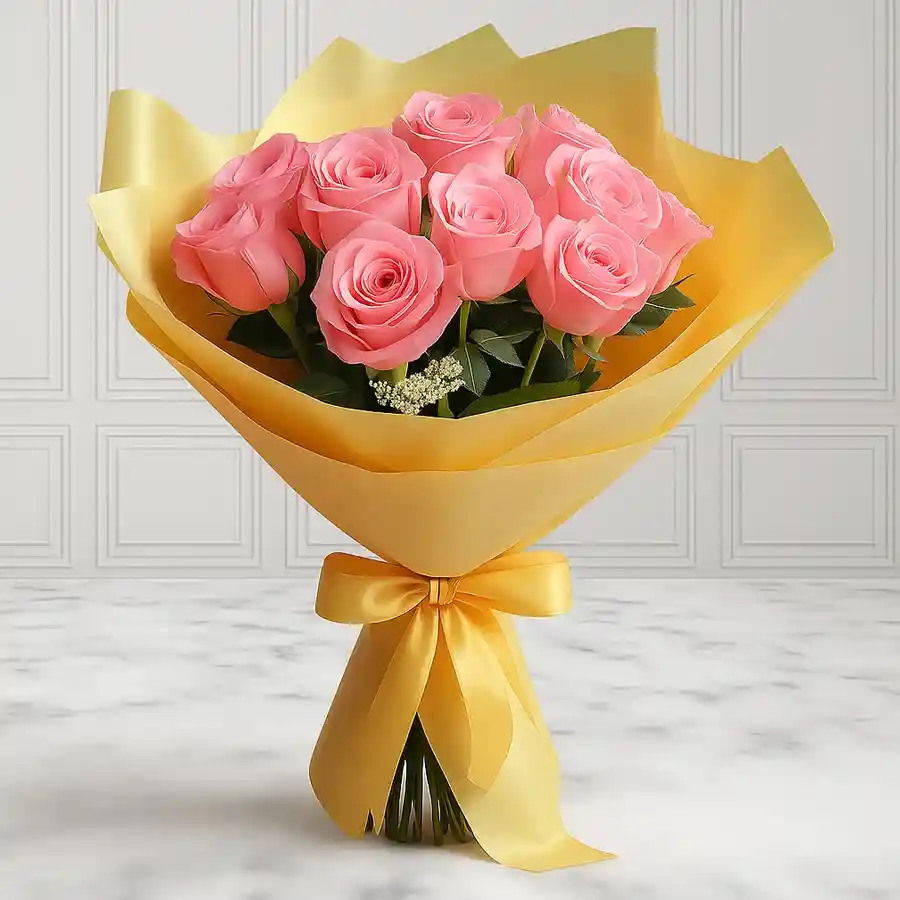Bouquet of 12 pink roses elegantly wrapped in soft yellow tissue.