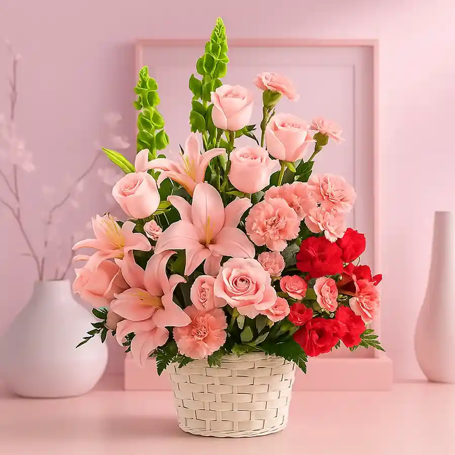 Classic arrangement featuring red and pink roses, pink carnations, and pink lilies, symbolizing love and affection.