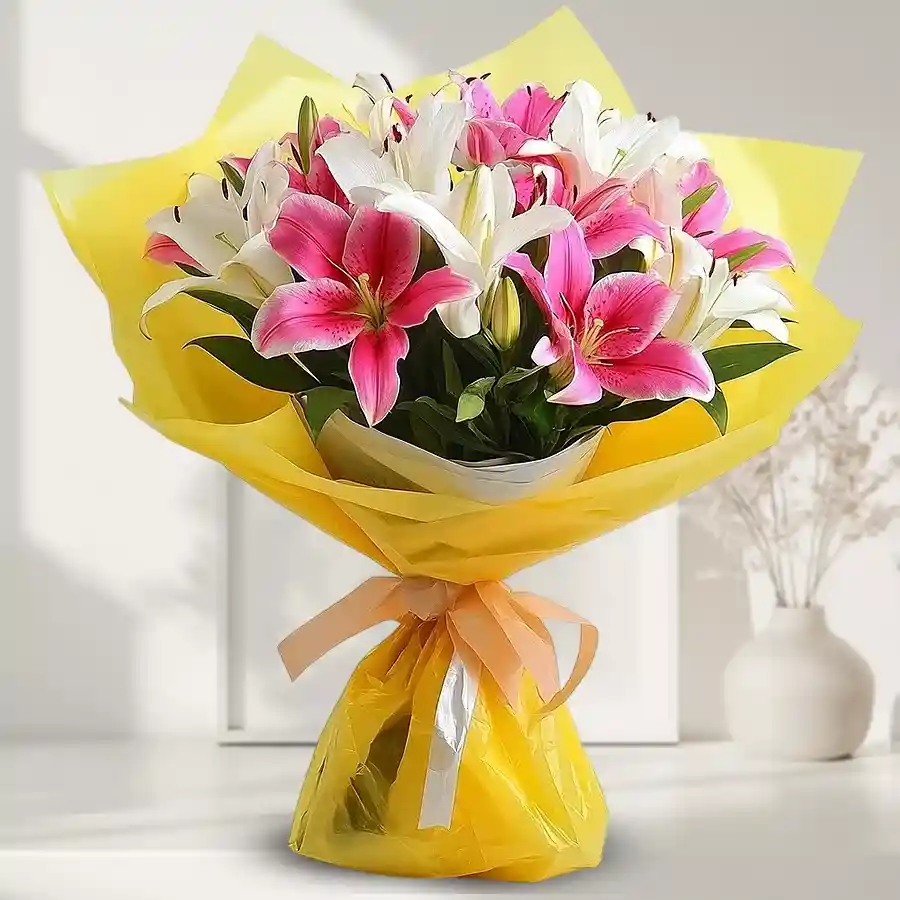Charming arrangement of 10 pink and white lilies in a bouquet.