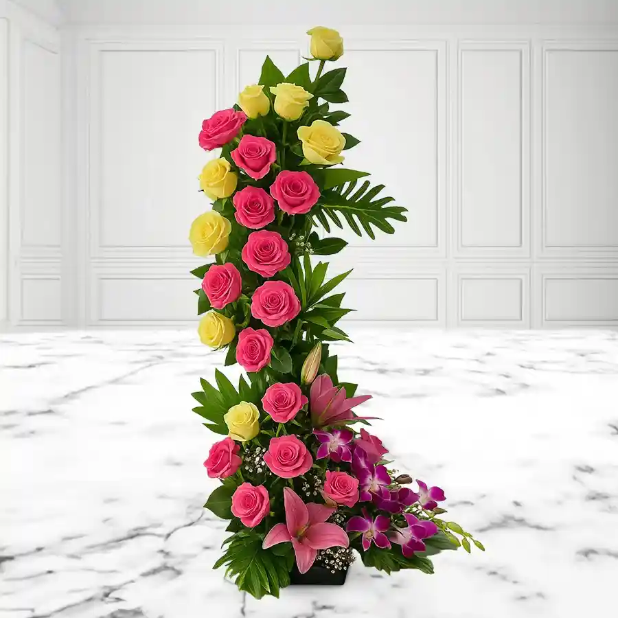 Dazzling 2ft standing floral arrangement featuring Yellow Roses, Pink Roses, Yellow Carnations, Pink Lilies, and Purple Orchids.