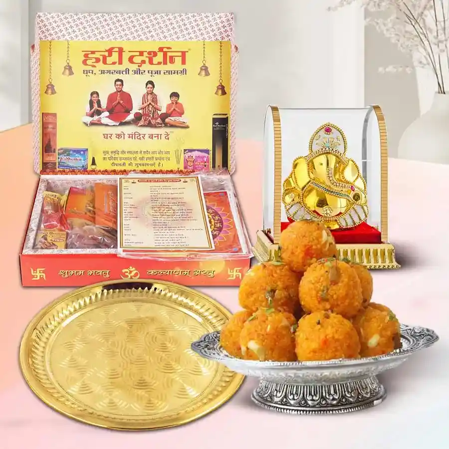 Captivating Diwali Pooja items including a gold-plated thali, a Ganesha idol, essential Puja samagri, and Ghee Ladoo in a festive arrangement.