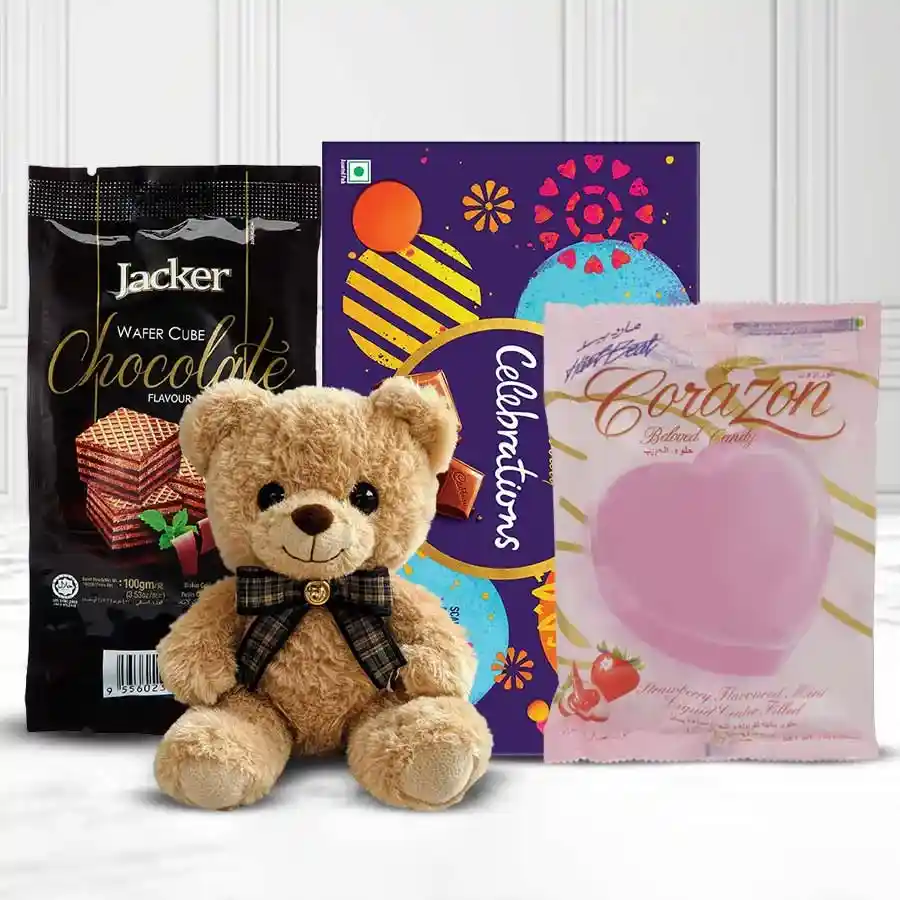 Assorted chocolates and a teddy bear in a gift basket