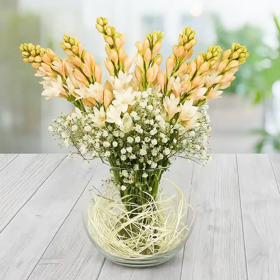 10 Rajnigandha flowers elegantly displayed in a sleek glass vase.
