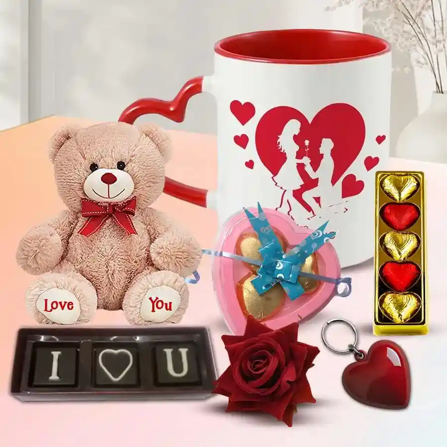 A romantic gift set featuring chocolates, a card, a singing teddy bear, a velvet rose, a heart keyring, and a love mug, all arranged beautifully.