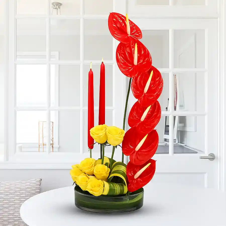 A beautifully arranged gift set featuring yellow roses, red anthuriums, and candles, perfect for expressing love and celebrating special moments.