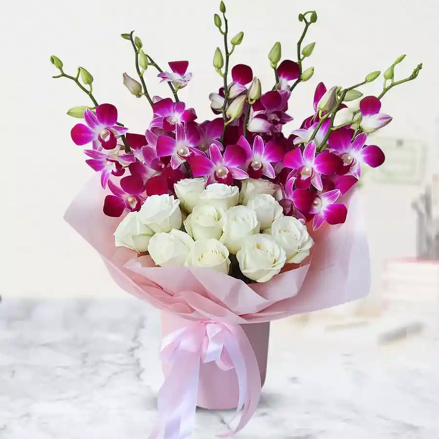 A beautiful bouquet featuring 10 orchids and 10 white roses, wrapped in delicate tissue.