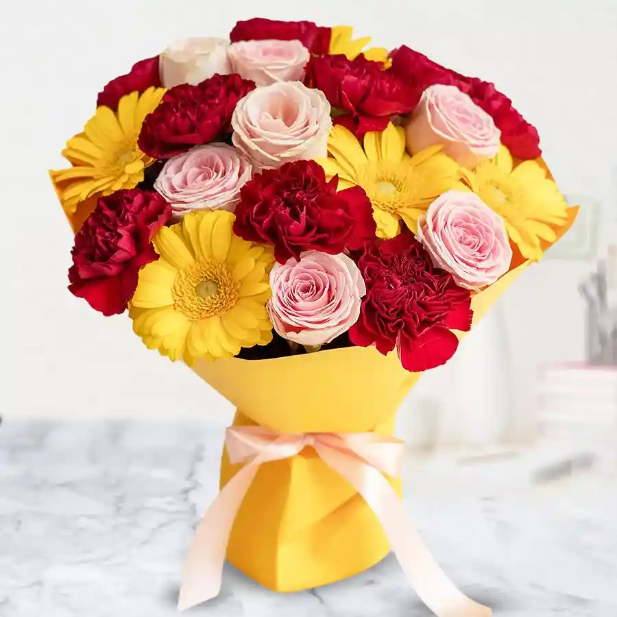 Blossoms of Affection Trio Bouquet featuring 9 Carnations, 9 Gerberas, and 9 Roses wrapped in soft tissue, perfect for expressing love and friendship.