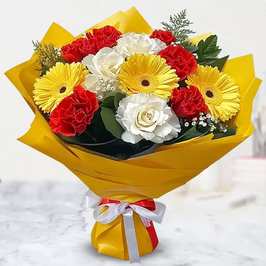 Exquisite arrangement of 7 roses, 5 carnations, and 3 gerberas wrapped in tissue, showcasing vibrant floral beauty.