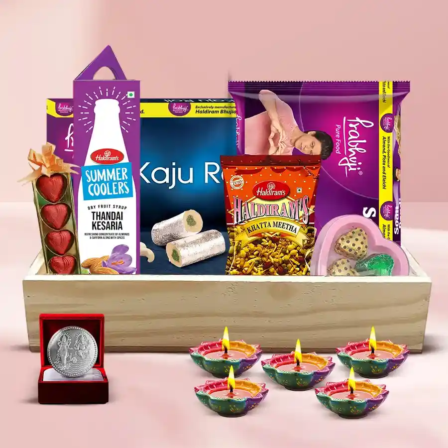 Fascinating Diwali Gift Tray filled with heart-shaped chocolates, Haldiram sweets, snacks, Thandai, diyas, and a Laxmi Ganesh silver-plated coin.