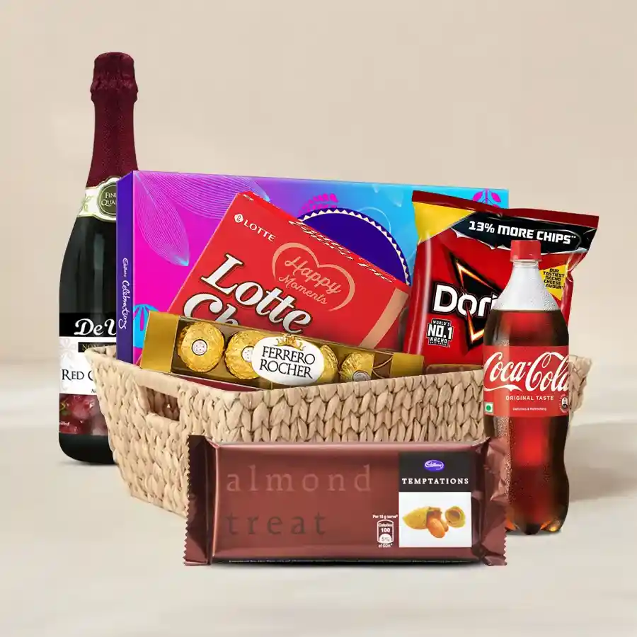 A colorful Sweet Indulgence hamper featuring chocolate, chips, and a bottle of sparkling fruit wine, perfect for gifting or celebration.