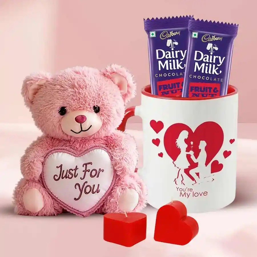 Exquisite Love You Gift Hamper featuring a Love Mug, two Love Candles, a Teddy Bear with a heart-shaped cushion, and Cadbury Dairy Milk Fruit & Nut bars
