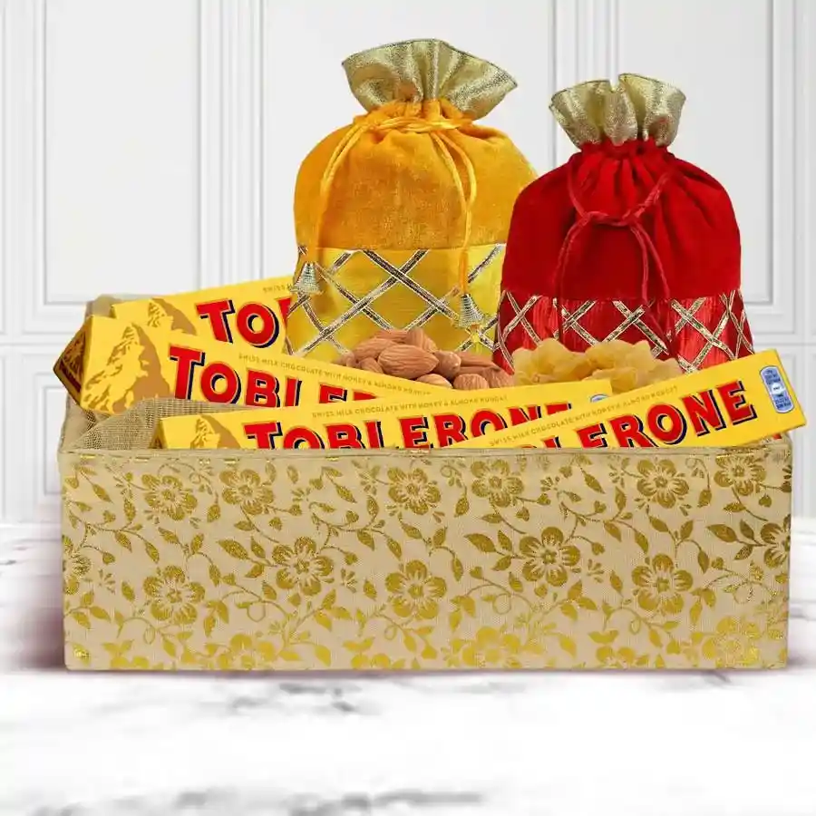 Deepavali gift basket featuring four Toblerone bars and packs of almonds and raisins