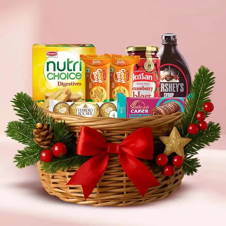 Festive Special Gift Basket filled with treats including Swiss Roll, Good Day Cookies, Ferrero Rocher chocolates, Hershey’s Chocolate Syrup, strawberry jam, and Nutrichoice Digestives, arranged in a decorative cane basket with Christmas decorations.
