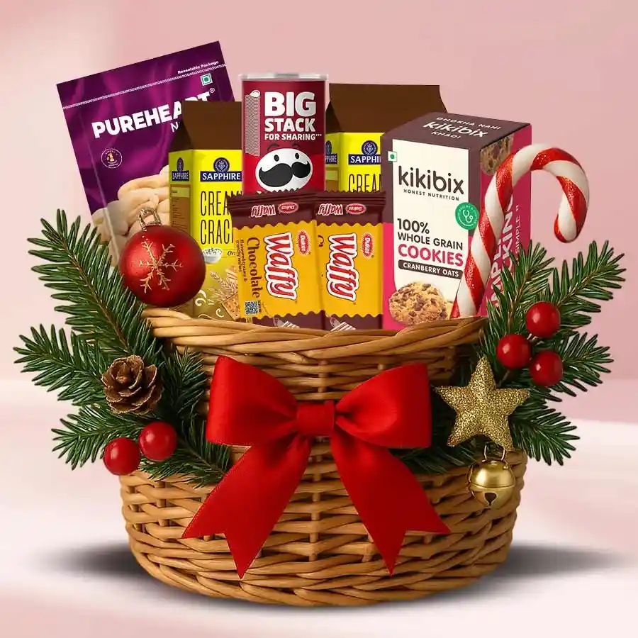 Nuts, cookies, and chips gift hamper arranged in a decorative box with Christmas decorations