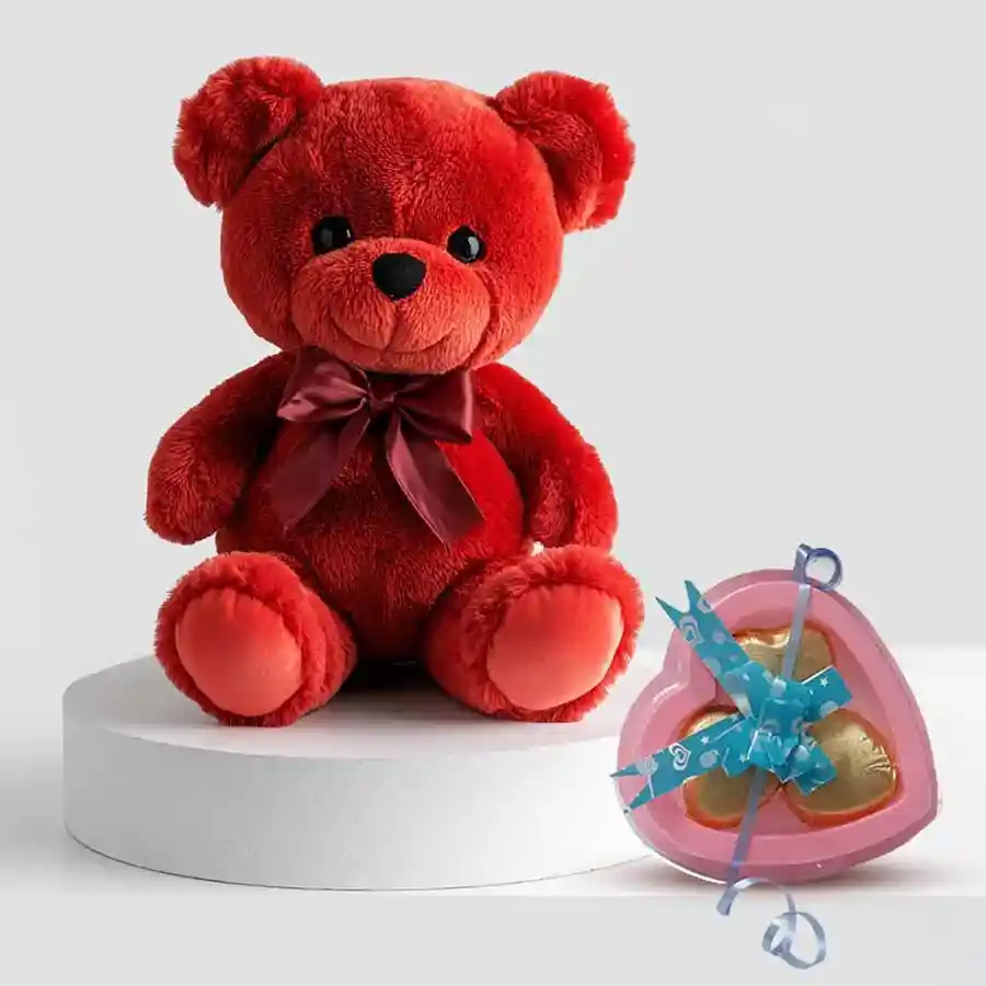 Cute red teddy bear holding heart-shaped chocolates for Valentine's Day gift.