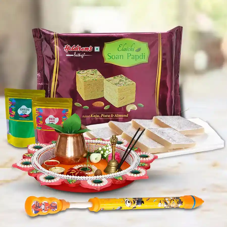 Colourful gift set featuring Haldiram Kaju Katli and Soan Papdi in a decorative Puja Thali with free Gulal and Pichkari for festive celebrations.