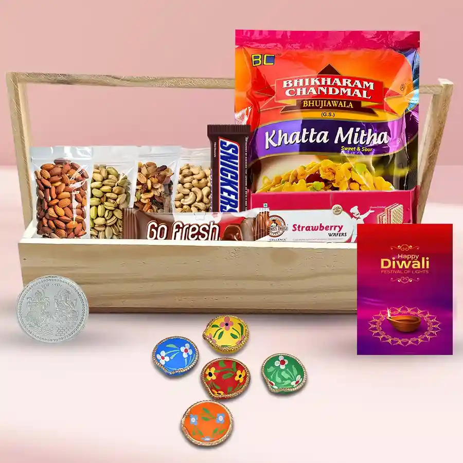Flavorful Gourmet Gift Tray featuring a silver-plated Ganesh Lakshmi coin, elegant Diwali cards, decorated diya set, Bhikaram Chandmal Khatta Meetha Namkeen, Snickers and Go Fresh chocolates, premium dry fruits, and gourmet strawberry wafers, all arranged on a chic tray.