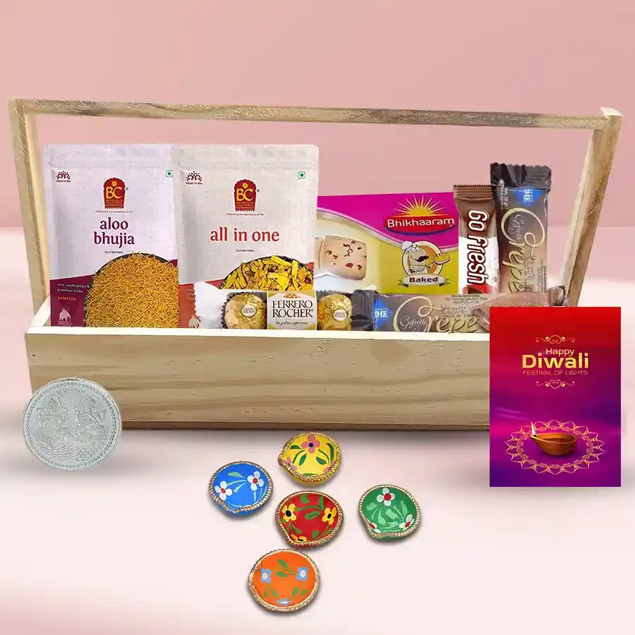 Tasty Sweets N Namkeen Diwali Combo Hamper featuring crepe choco bars, Ferrero Rocher, Go Fresh choco bar, Bhikaram's Chanachur, Froot Bite, Alu Bhujia, decorated diyas, silver-plated Ganesh Lakshmi coin, and a Diwali card on a stylish tray.