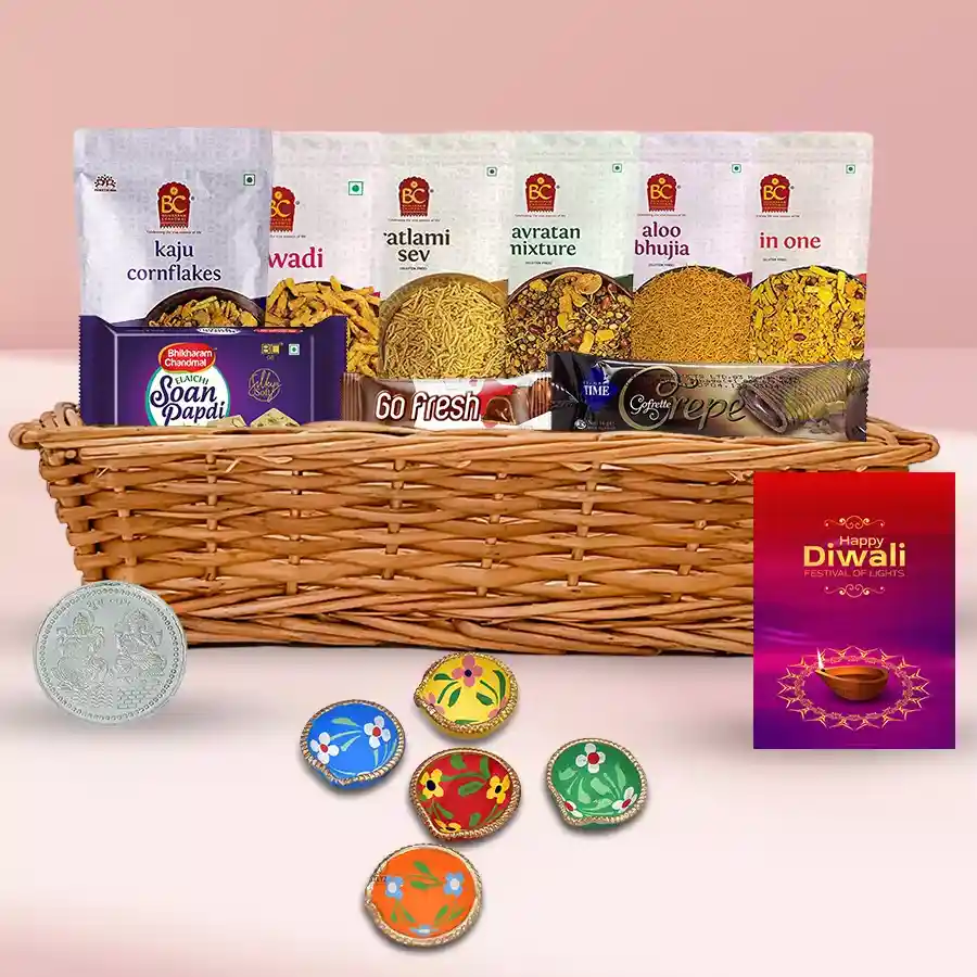 Festive Time Diwali Greetings Gift Basket with assorted treats, Diya set, Diwali card, and silver-plated Ganesh Lakshmi coin in an elegant basket.